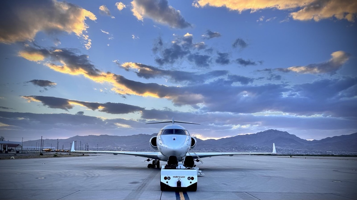 Private jet on runway at sunset